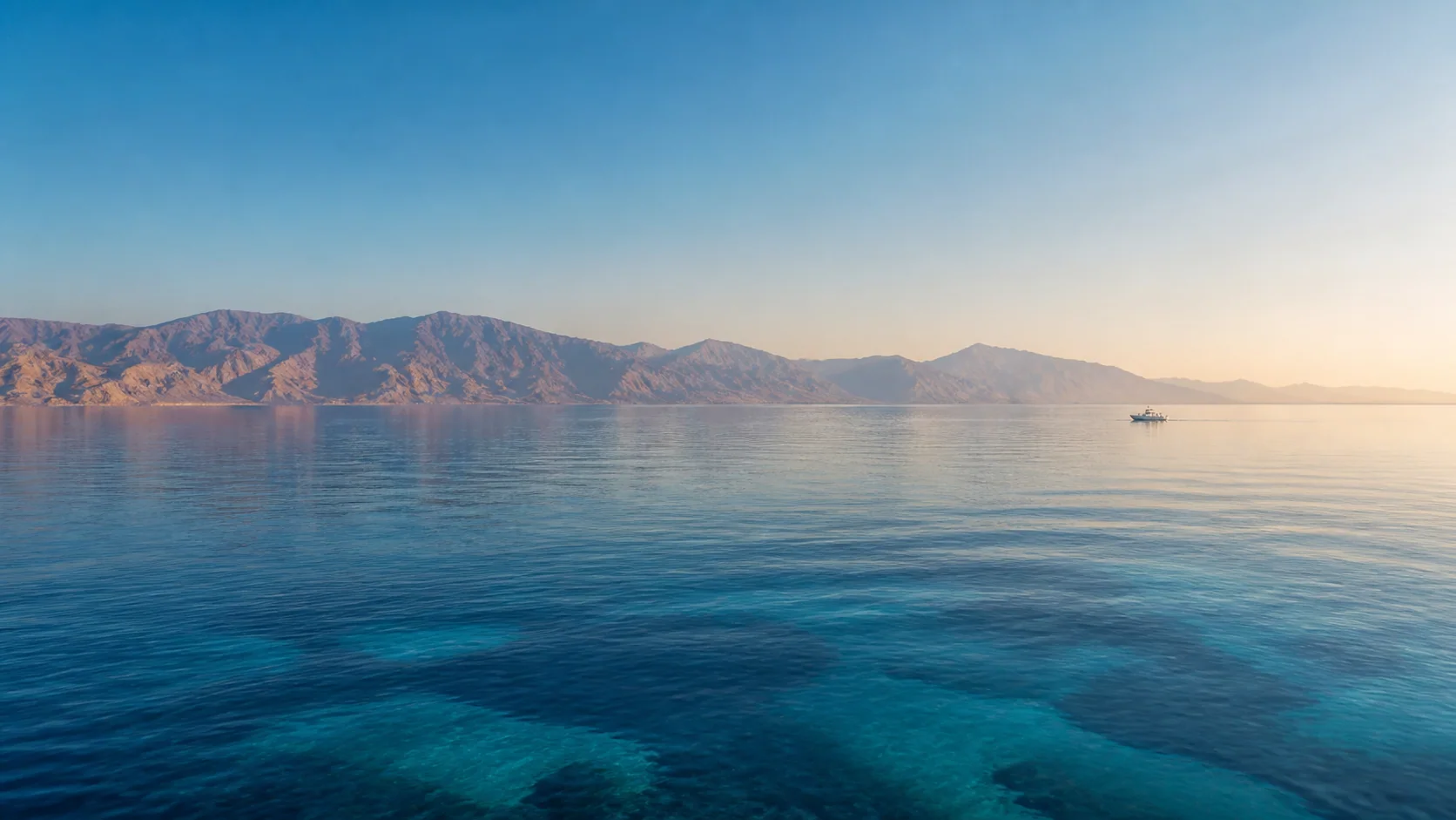 Calm Red Sea coastline and distant support vessel